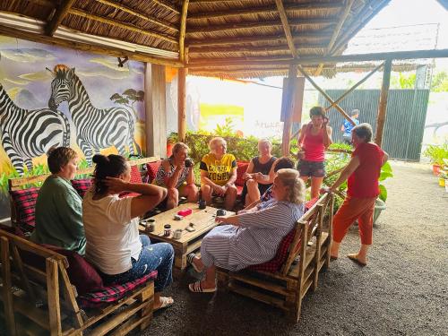 a group of people playing a game with a zebra on the wall at Safari villa in Arusha