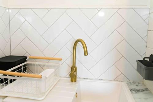 a kitchen with a sink and a gold faucet at The Apiary in Killarney