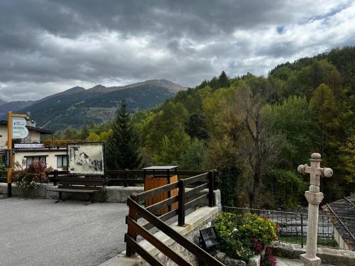 a church with a cross on the side of a road at Les Arnauds natura & relax in Bardonecchia