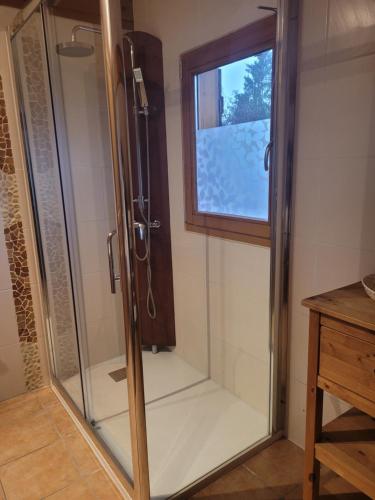 a glass shower in a bathroom with a window at Chalet Mauselaine in Xonrupt-Longemer