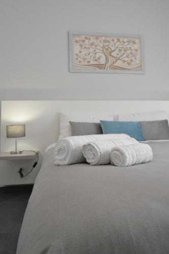 a bed with a bunch of rolled towels on it at Da 'Nfacci Affittacamere in Carini