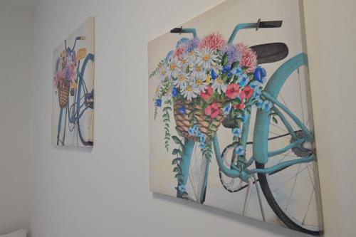 a painting of a bicycle with flowers on a wall at Da 'Nfacci Affittacamere in Carini