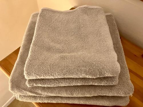 uma pilha de toalhas sentadas em cima de uma mesa em Yew Tree House, Bed & Breakfast in Colchester em Lexden