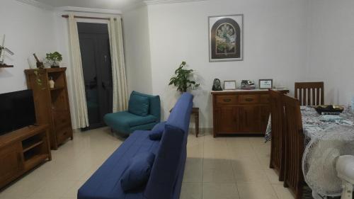 a living room with a blue couch and a chair at JS crecer in San Sebastián de la Gomera