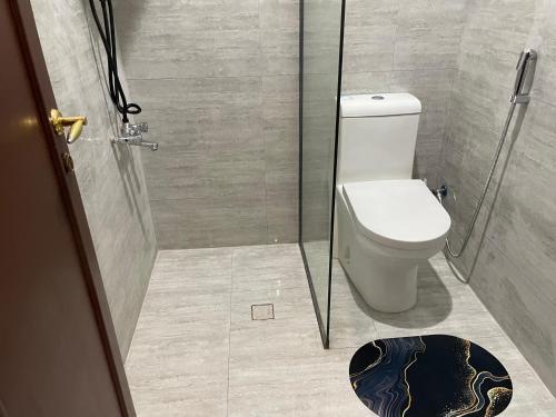 a bathroom with a toilet and a glass shower at شقة بيروت 2 in Riyadh