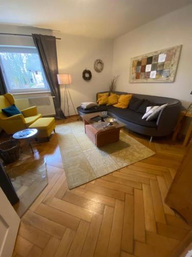 a living room with a couch and a table at Das Alte Forsthaus Spiegelhütte in Lindberg