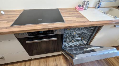 a kitchen with a dishwasher and a counter top at Ferienwohnung Angie in Vogtsburg