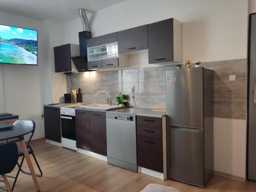 a kitchen with a stainless steel refrigerator and a sink at Mini Apartament Studio in Głuchołazy