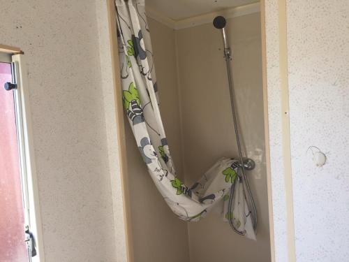 a shower curtain is hanging in a door at Sunset Milfontes in Vila Nova de Milfontes