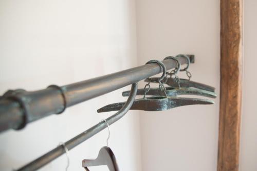 a metal towel rack with pairs of glasses at L’Été en Novembre in Kirrwiller