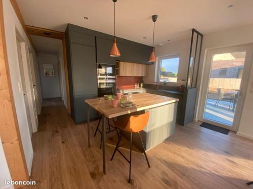 a kitchen with a wooden island in a room at Ker Melen in Cléder