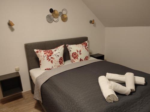 a bedroom with a bed with rolled towels on it at Haus Marika in Siófok