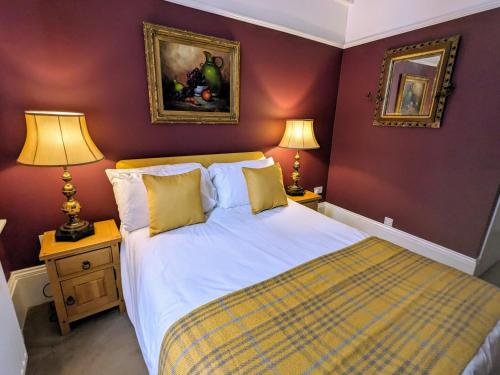 a bedroom with a large bed and two lamps at Archway House in Grantham