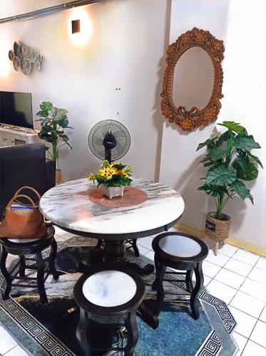 a room with a table and chairs and a mirror at Bidadari Lagoon 4 Islamic Homestay in Port Dickson