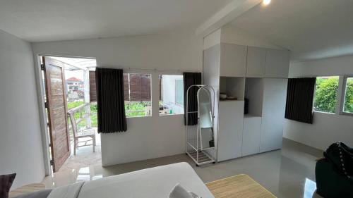 a white kitchen with a glass shower in a room at Kampoeng Saya in Seminyak