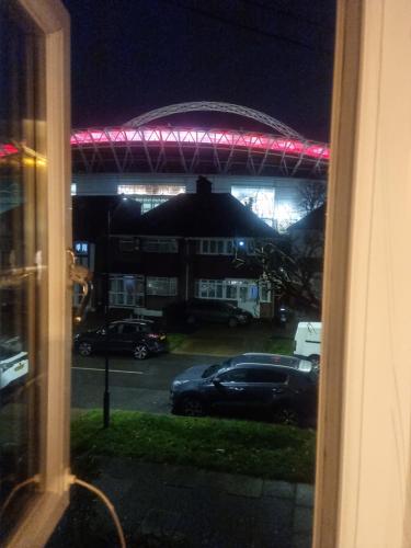 a view from a window of a parking lot at night at The Manor Guest House in Wembley in London