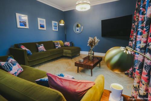 a living room with a couch and a tv at Fair Rigg by Cradel Haus - Ultra Luxury Lakes Holiday Homes, Pet Friendly, Parking & EV Plug in Bowness-on-Windermere