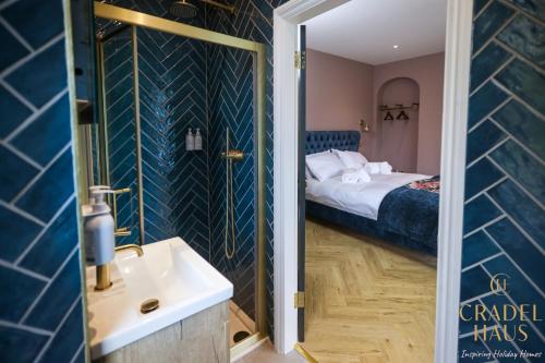 a bathroom with a sink and a bed at Fair Rigg by Cradel Haus - Ultra Luxury Lakes Holiday Homes, Pet Friendly, Parking & EV Plug in Bowness-on-Windermere