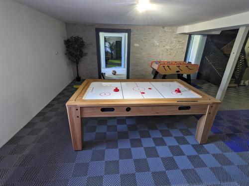 a ping pong table in the middle of a room at Villa Morton - Domaine du Grand Tourmalet Pic du Midi in Bagnères-de-Bigorre