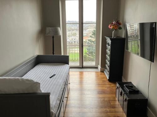 a bedroom with a bed and a large window at Villa Morton - Domaine du Grand Tourmalet Pic du Midi in Bagnères-de-Bigorre