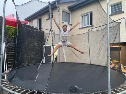 a young girl jumping on a trampoline at Le 53-Maison de campagne-LES MAKES in Saint-Louis