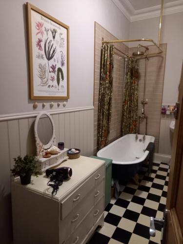 a bathroom with a tub and a sink at Hebble End View B&B in Hebden Bridge