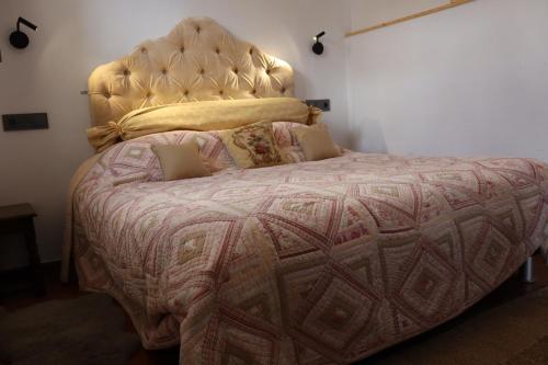 a bedroom with a large bed with a large headboard at Los Castaños, Vivienda Rural, Capileira in Capileira