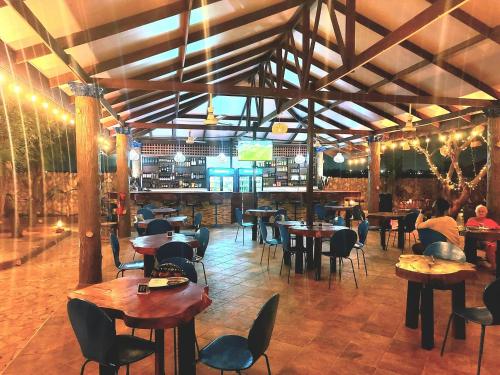 un restaurante con mesas y sillas y un bar en Blue Palm Resort Ghana, en Abia