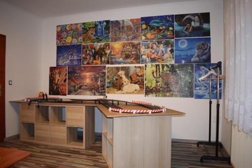 a desk in a room with a wall with posters at Spacious house in the outskirts of Budapest in Budapest