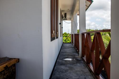 a corridor of a house with a walkway at Baobab Bungalows in Jambiani