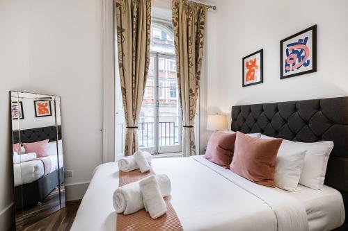 a bedroom with a large bed with towels on it at Welcome London Mayfair in London