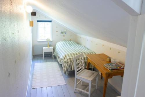 niewielka sypialnia z łóżkiem i biurkiem w obiekcie Romantic villa on old Mansion w mieście Säffle
