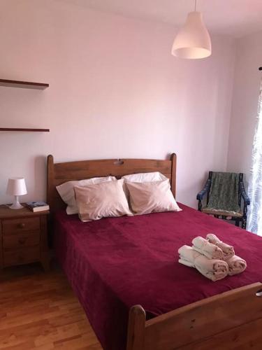 a bedroom with a bed with a red bedspread at The South Sunny House - A Casa a Sul in Olhão