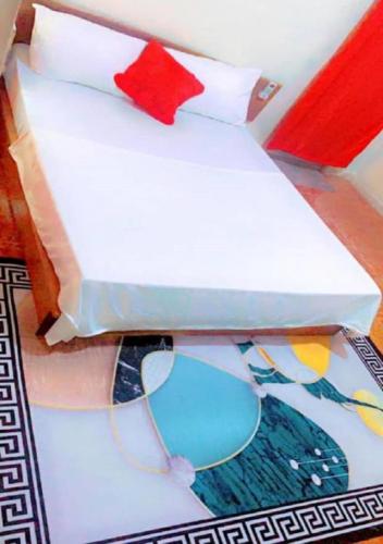 two white boxes sitting on top of a rug at Welcome to Hilltop Villa in Dakar