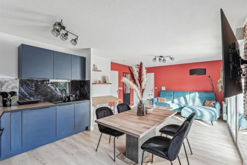 a kitchen and dining room with a table and chairs at Comfort and tranquility near Lyon and Groupama Stadium, 4 personnes in Meyzieu