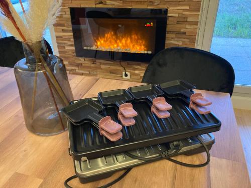 a grill with four donuts on it in front of a fireplace at Comfort and tranquility near Lyon and Groupama Stadium, 4 personnes in Meyzieu