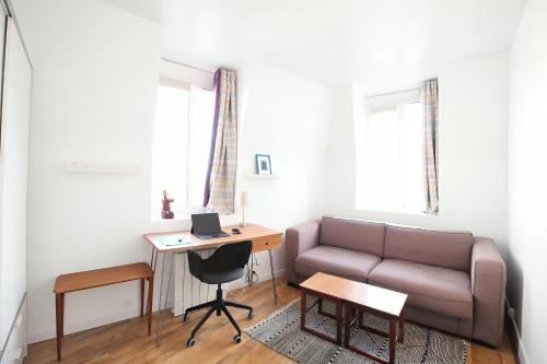 un salon avec un canapé et un bureau dans l'établissement 3P cosy et lumineux proche de La Défense et Paris, à La Garenne-Colombes