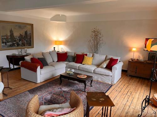 a living room with a couch and a table at les loges du chaudron in La Chapelle-aux-Choux
