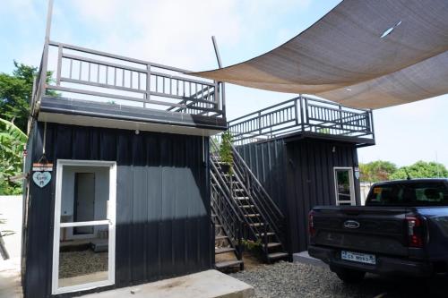 a black tiny house with a ramp and a truck at Canto Tièro Cabin 1 in Batangas City