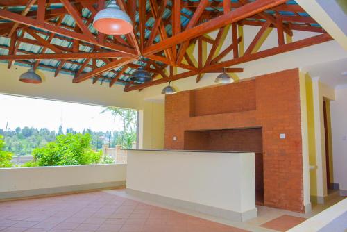 a large room with a white table in front of a fireplace at House of DC- stylish 2 bedroom apartment in Kahawa