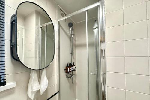 a bathroom with a mirror and a shower at No.1 Lighthouse Dawlish Beach in Dawlish