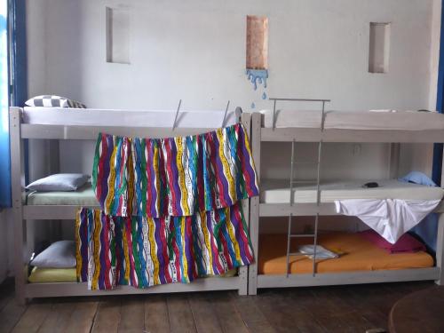 a room with two bunk beds with ties on them at Hostel Torre Bahia-Familia in Salvador