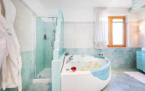 a bathroom with a bath tub and a shower at L’Attico sul Mare - Exclusive Penthouse, Vieste in Vieste
