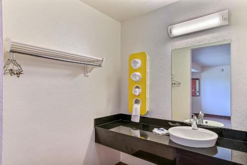 a bathroom with a sink and a mirror at Motel 6-Pinole, CA in Pinole