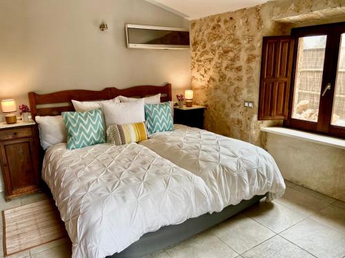 a bedroom with a bed and a window at Finca Sa Canova Agroturismo in Campos