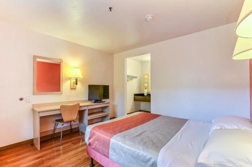 a hotel room with a bed and a desk at Motel 6-Pinole, CA in Pinole