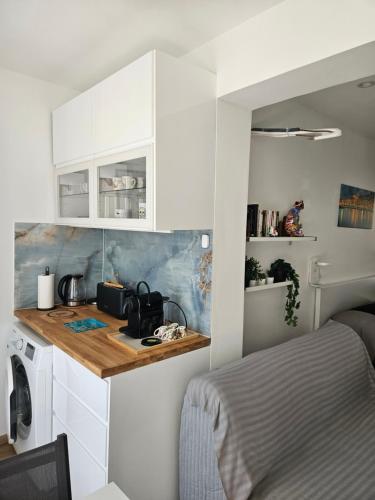 une cuisine avec des armoires blanches et un comptoir dans l'établissement Lovely appartement near sea and Monaco with free parking, à Roquebrune-Cap-Martin