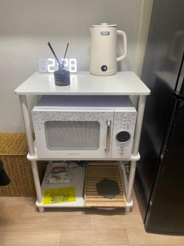 a white table with a microwave on top of it at Nroo Stay in Seoul