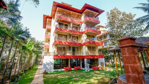 a tall building with red chairs in front of it at 360 Bliss Dia Hotels in Nerul