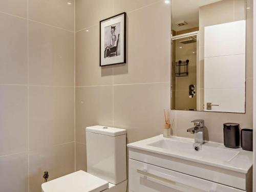 a white bathroom with a toilet and a sink at 2 Bed in Lizard 45739 in Ruan Major